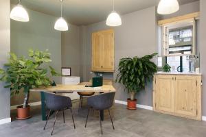 a dining room with a wooden table and chairs at Hotel 22 Marzo in Milan