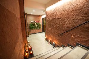 a hallway with stairs and a sign on a wall at Tuzla Garden Hotel & Spa in Tuzla