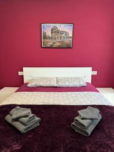 a bedroom with a bed with towels on it at West Park Apartment in Sofia