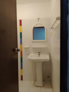 a bathroom with a sink and a window at Hotel arugambay beach inn resort in Arugam Bay