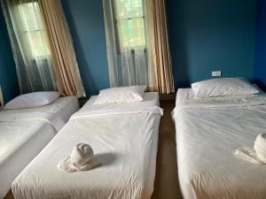 Postel nebo postele na pokoji v ubytování T&P at Pai