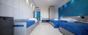 Postel nebo postele na pokoji v ubytování Hotel Blu Eden