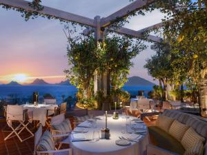 a restaurant with tables and chairs with a view of the ocean at Swissôtel Resort Bodrum Beach in Turgutreis