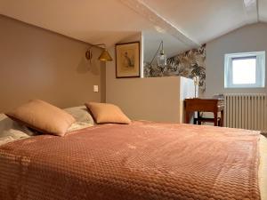 a bedroom with a bed with an orange comforter at Appartement vue Loire - Chez Lulu la Nantaise in Rezé