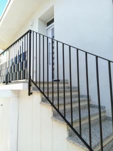 a staircase in a house with a view of the ocean at La GemMa in Santa Maria Navarrese
