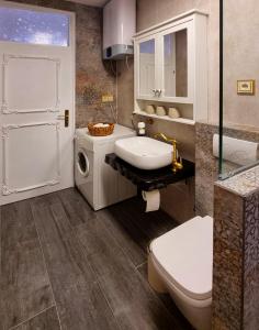 a bathroom with a white sink and a toilet at Apartment Bakarosa in Pučišća +33 photos