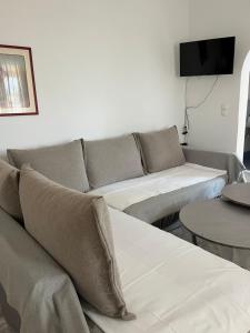 a living room with a couch and two tables at Harry's House in Elafonisos