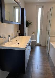 a bathroom with a sink and a toilet at Uilzicht in Velden +10 photos