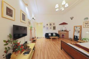 a living room with a television and a couch at Cozy Fun Homestay 12 in Hanoi