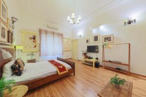 a large room with a bed and a television at Cozy Fun Homestay 12 in Hanoi