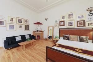 a bedroom with a bed and a couch and a fireplace at Cozy Fun Homestay 12 in Hanoi +2 photos