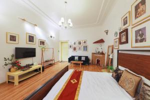 a large living room with a bed and a flat screen tv at Cozy Fun Homestay 12 in Hanoi
