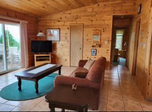 un salon avec un canapé et une table dans l'établissement True Living Oceanfront Cottage, à Cumberland