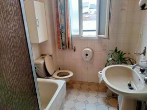 a bathroom with a toilet and a sink at Maison et Appartement in La Courneuve +6 photos