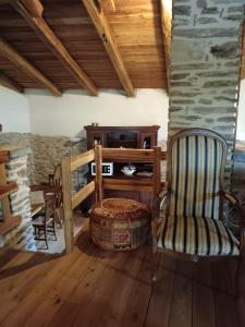 a living room with a chair and a table at Casa delle Rose - Marmora in Marmora +19 photos