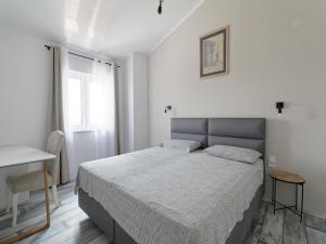 a bedroom with a bed and a table and a window at Villa Matthias by Rent Istria in Ližnjan +32 photos
