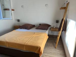 un dormitorio con una cama con una escalera al lado en La campagne au bord de la mer, en Porto Vecchio