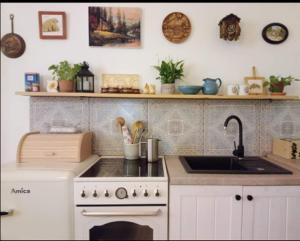 a kitchen with a white stove and a sink at Pod kláštorom in Svätý Beňadik