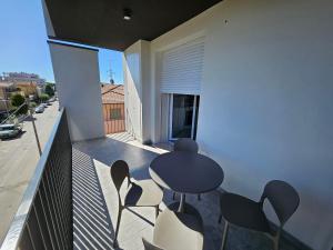 a balcony with a table and chairs on a balcony at CasaMARina in Misano Adriatico +6 photos