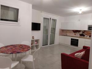 a living room with a red couch and a table at CasaMARina in Misano Adriatico