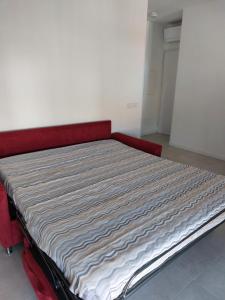 a bed in a room with a red bed frame at CasaMARina in Misano Adriatico