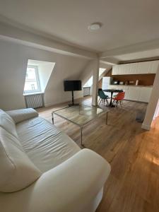 a living room with a white couch and a table at Reichel Sophien Appartements in Baden-Baden