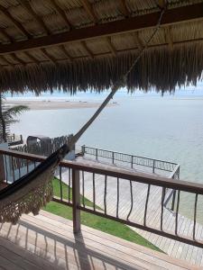 a hammock in a resort overlooking the beach at Casa Caju Tatajuba in Tatajuba +47 photos