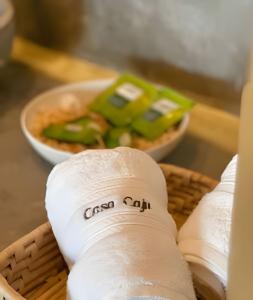 a basket of wrapped food with a bandaged arm and a bowl of fruit at Casa Caju Tatajuba in Tatajuba