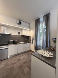 a kitchen with white cabinets and a counter top at Le Finestre Veneris in Portovenere
