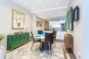a kitchen with a table and a green cabinet at Apartment Ruzafa Zapadores in Valencia