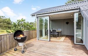 a barbecue on the deck of a house at Holiday Home Tranebærvej Thisted Iv in Nørre Vorupør