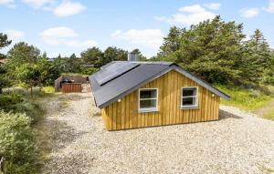 a small yellow building with a black roof at Holiday Home Tranebærvej Thisted Iv in Nørre Vorupør +12 photos