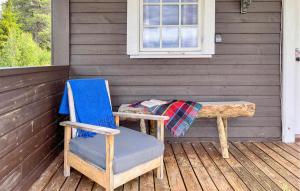 a table and a chair sitting on a porch at Holiday Home Gol Nystølfjellet Drengestugu in Sanderstølen