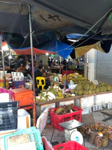 a market with a bunch of fruits and vegetables at City hotel in Sibu