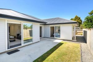 a house with sliding glass doors in a yard at Private room in homestay in Ashhurst