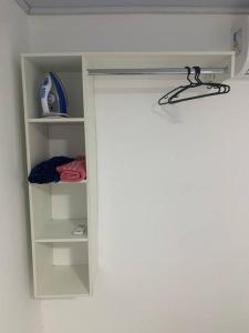 a door to a closet with a door open at Apartamento Confortável e moderno in Boa Vista