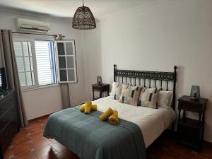 a bedroom with a bed with two teddy bears on it at Casa Cueva de los Verdes in Punta Mujeres