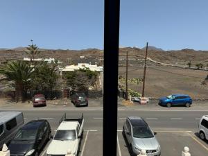 a view from a window of a parking lot with cars at Casa Cueva de los Verdes in Punta Mujeres