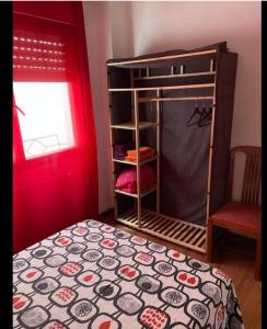 a bedroom with a bunk bed and a red door at Habitación Oviedo 2 in Oviedo