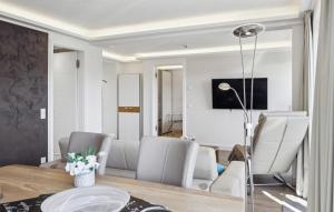 a dining room and living room with a table and chairs at Cloud in Binz
