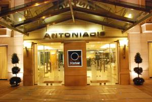 an entrance to a store with a sign on the door at Hotel Antoniadis in Kalabaka