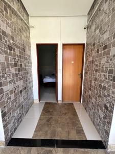 a hallway with two doors and a room with a bed at Hotel B&B in Santa Inês +26 photos