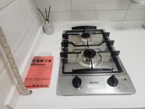 a stove top oven sitting on top of a counter at Haeundae Bada Residence in Busan
