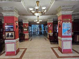 a hallway with columns and a chandelier in a building at Частен Апартамент Пампорово Гранд Манастира 2Б5 in Pamporovo +19 photos