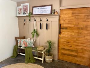 a room with a closet with a bench and a door at The Blue Shutter Guest House in Haenertsburg