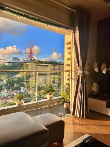 a room with a large window with a view of a city at Amber Homestay Hạ Long in Ha Long