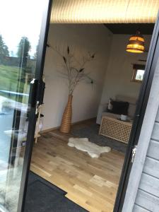 a glass door with a vase with a tree in it at Rum med sjöutsikt in Ockelbo