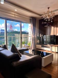 a living room with a couch and a large window at Amber Homestay Hạ Long in Ha Long