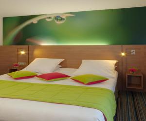 a hotel room with a bed and two lamps at Mercure Quimper Centre in Quimper