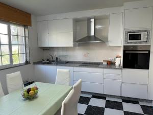 a kitchen with a table with a bowl of fruit on it at Casa de Meruso in San Pedro